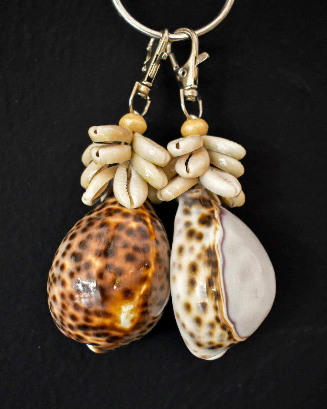 Shell and bead keychain on a black background