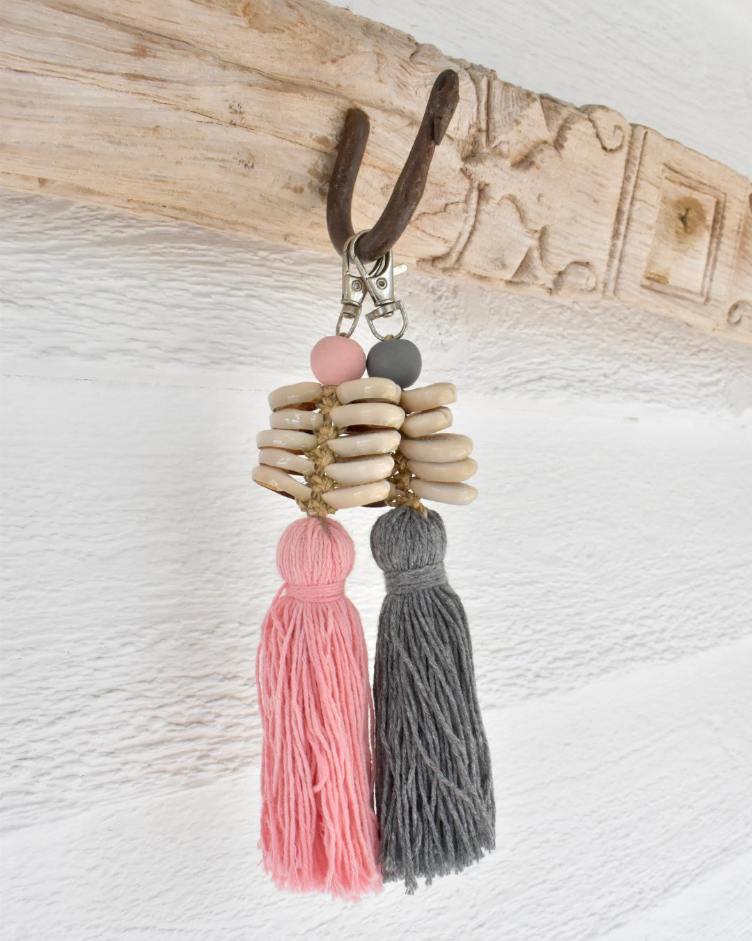 Keychain with tassels and beads on a textured surface