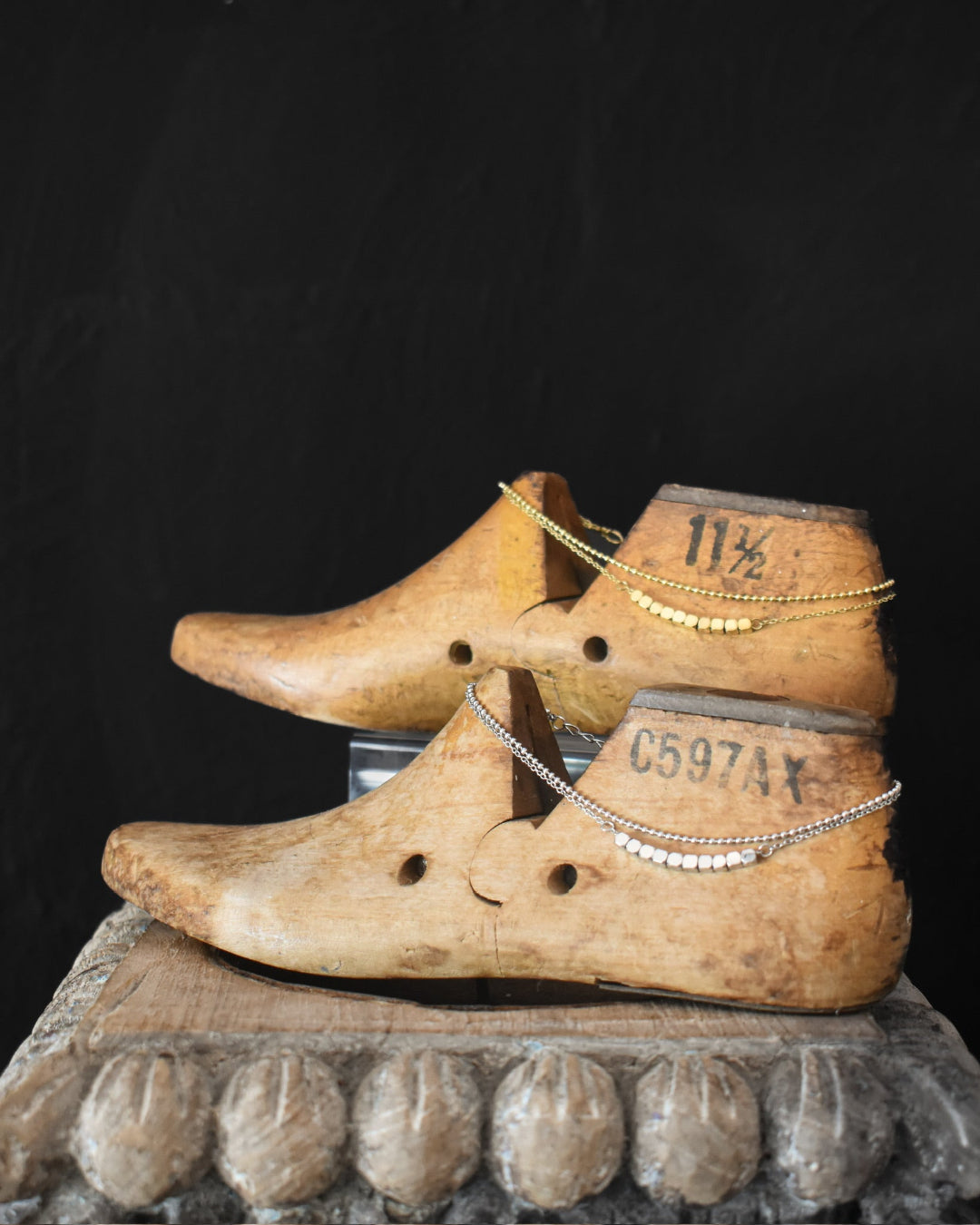 Wooden clogs with visible wear and a dark background