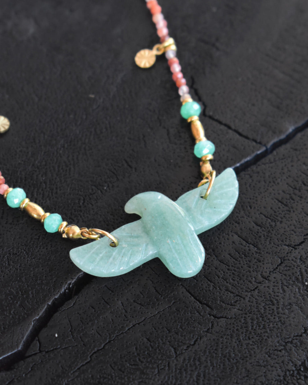 Necklace with a Eagle-shaped pendant on a dark surface