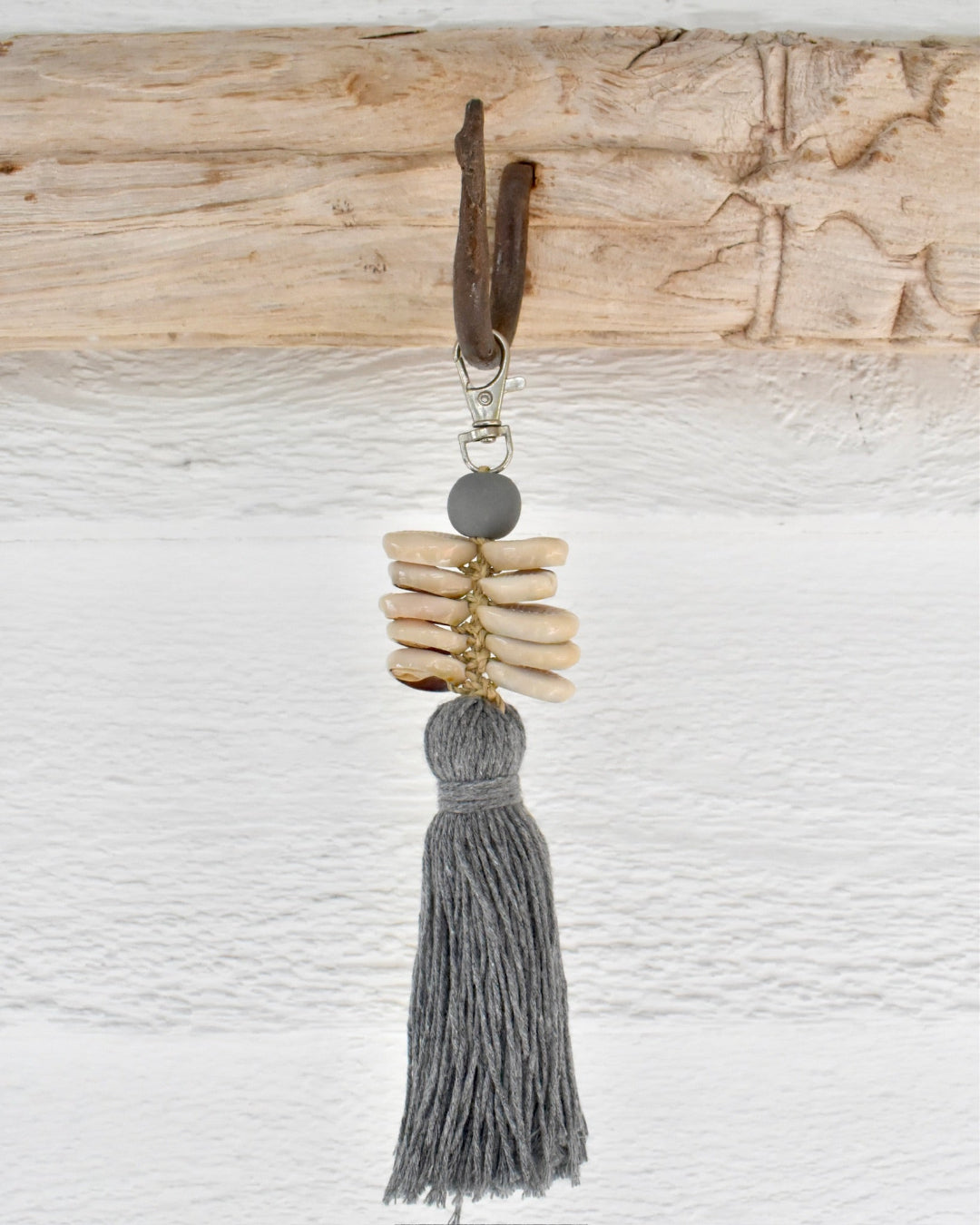 Keychain with tassel and natural elements on a textured surface