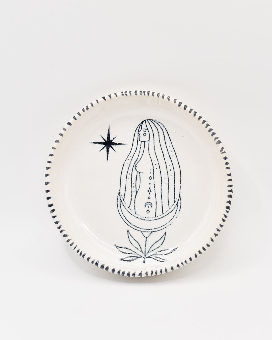 Decorative plate with a black and white illustration of a woman with long hair on a light gray background
