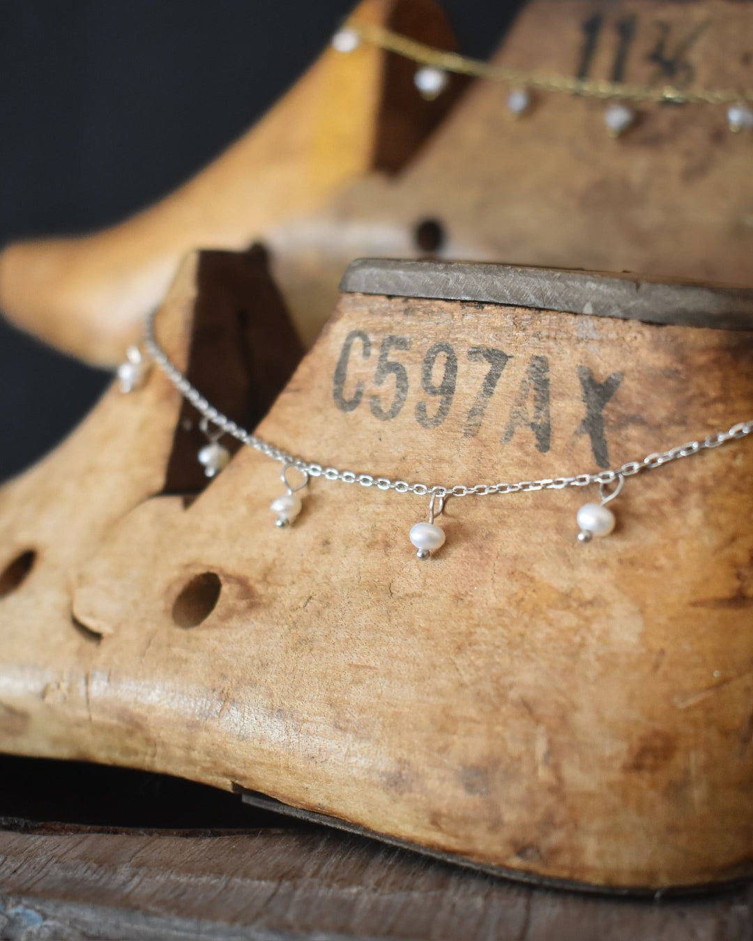 Necklace with heart-shaped pendants on a wooden shoe